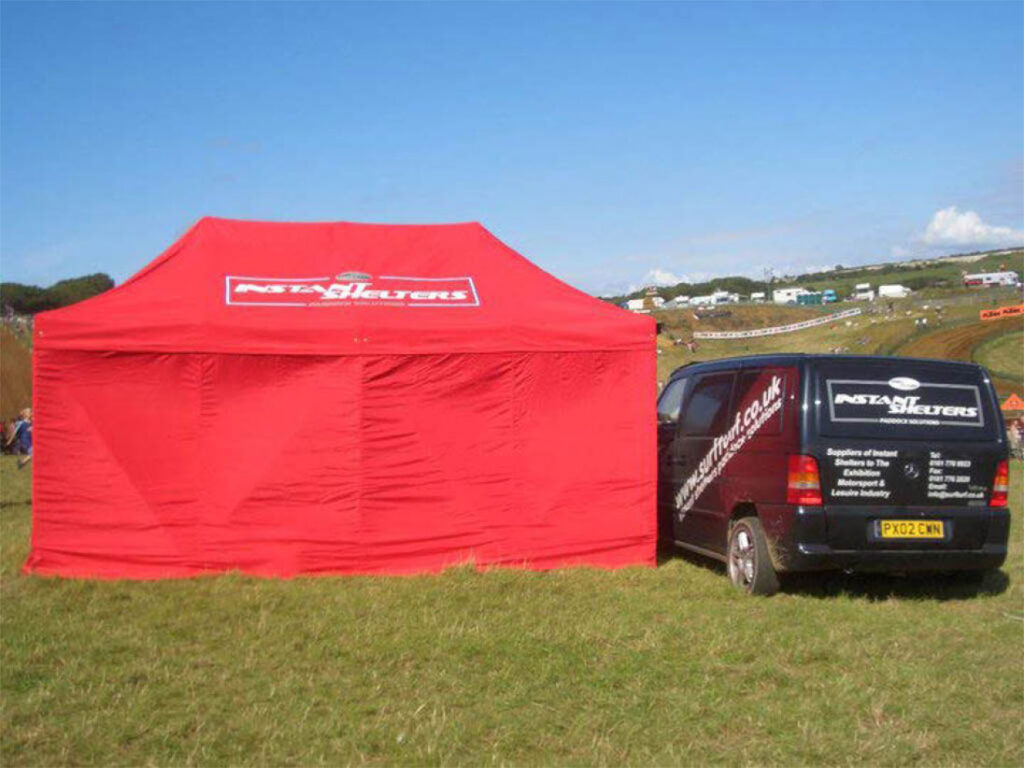 Old Surf & Turf gazebo and company van with its original branding from the early 2000s when the business was in its early days.