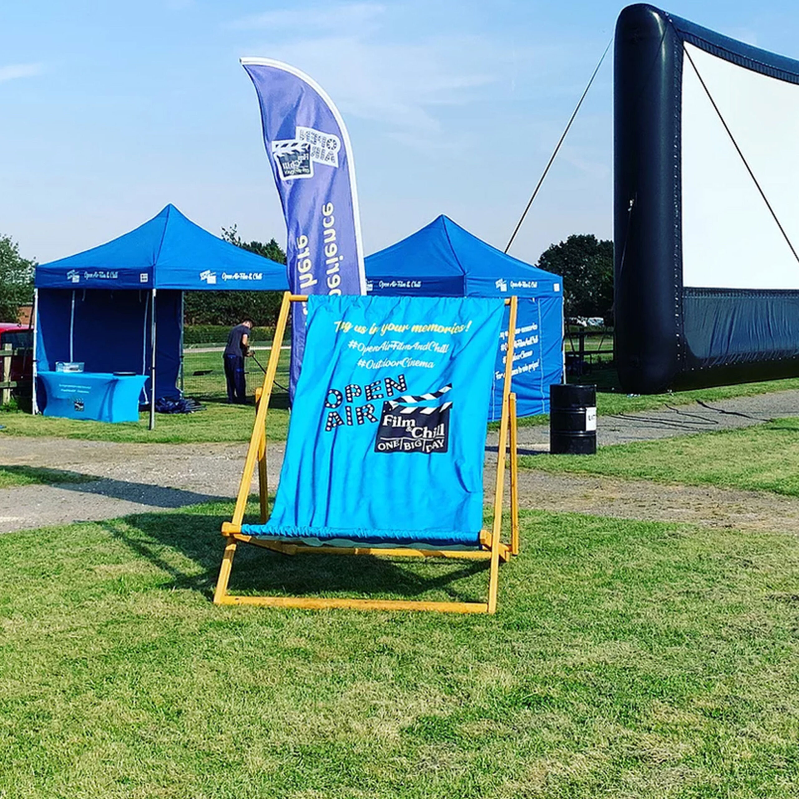 a custom-branded blue Giant Deckchair at an outdoor event