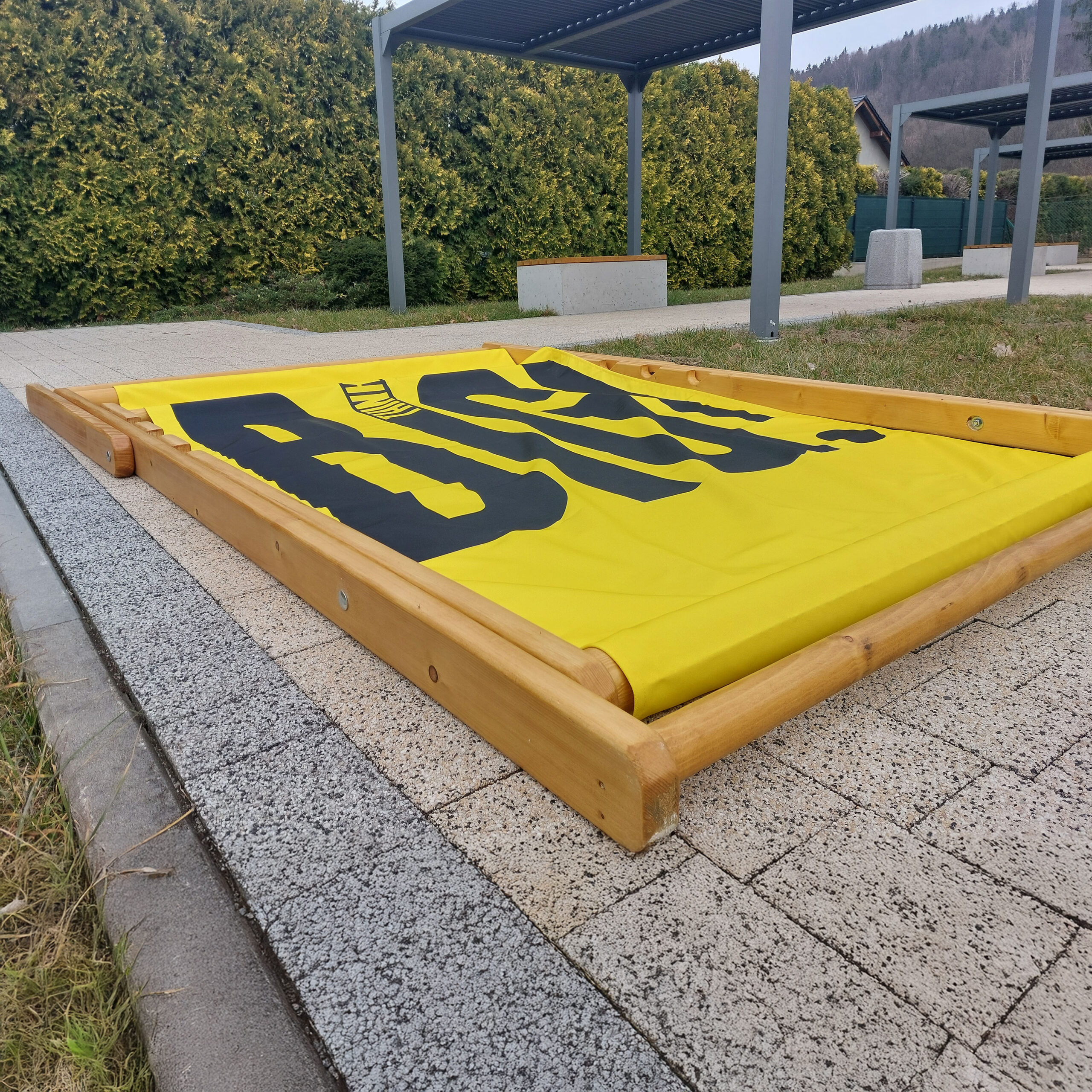 Folded Giant custom deckchair on a paved surface, demonstrating compact storage and easy transport capabilities.